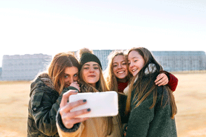 Four girls taking selfie outside