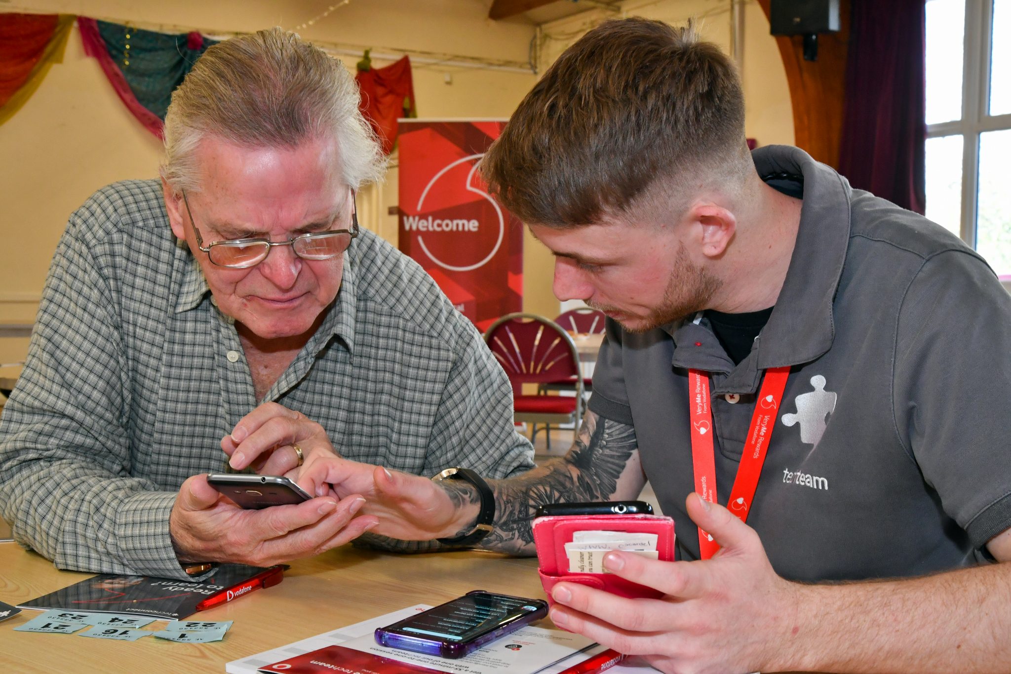 Photo of a Vodafone Tech Expert helping a man with his tech questions at a TechConnect event in Carnival Hall, Basingstoke, 26.02.19