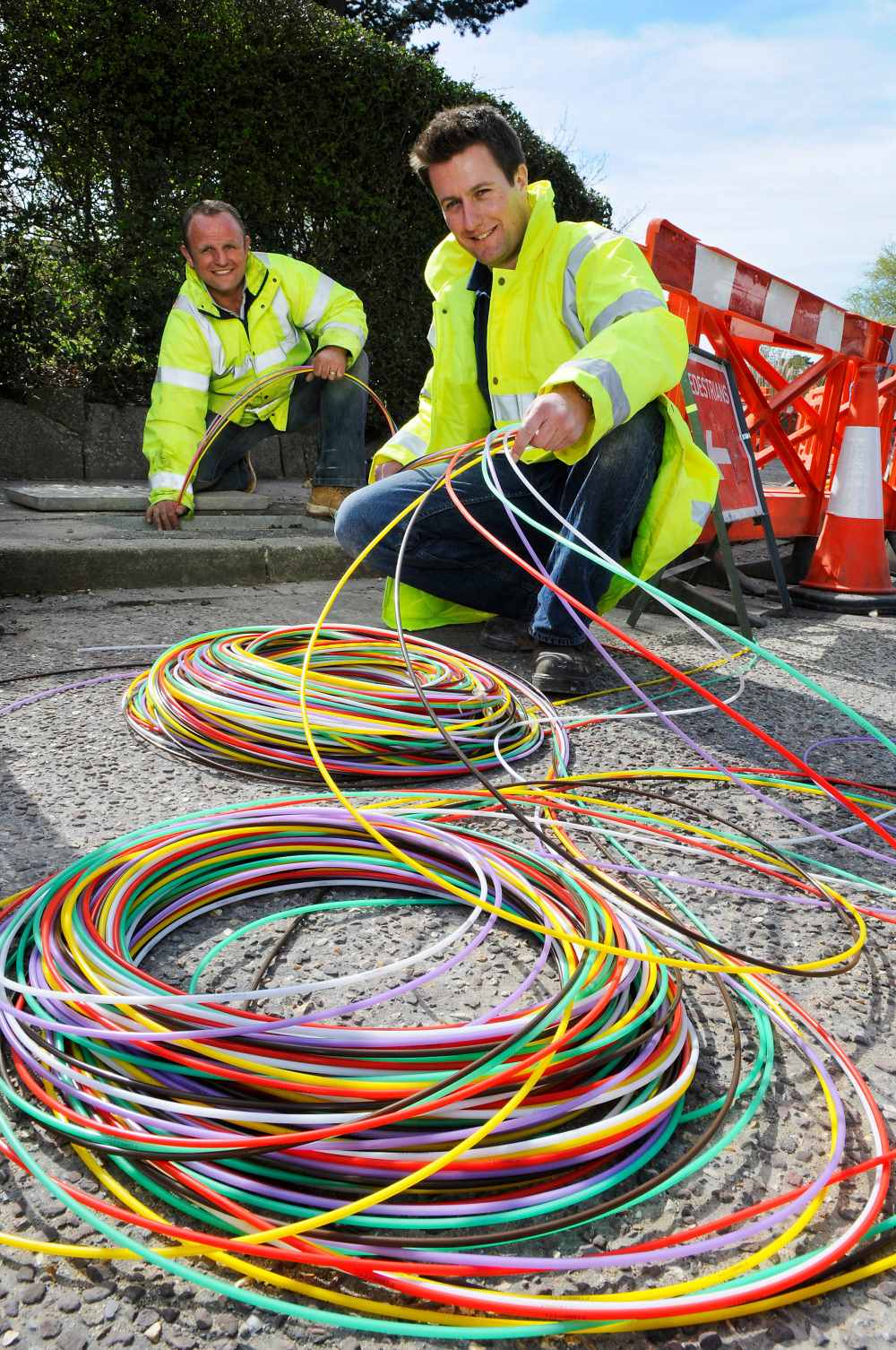 Workers lay gigabit capable fibre optic cable