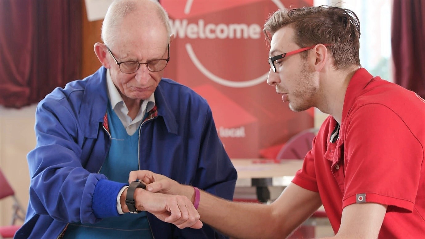 Vodafone tech expert shows elderly man how to use a smart watch