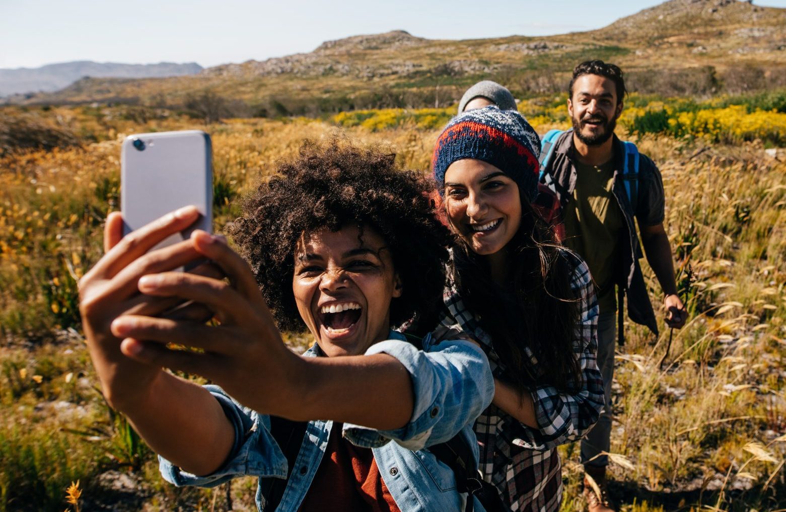 Friends hiking in the countryside and taking a selfie