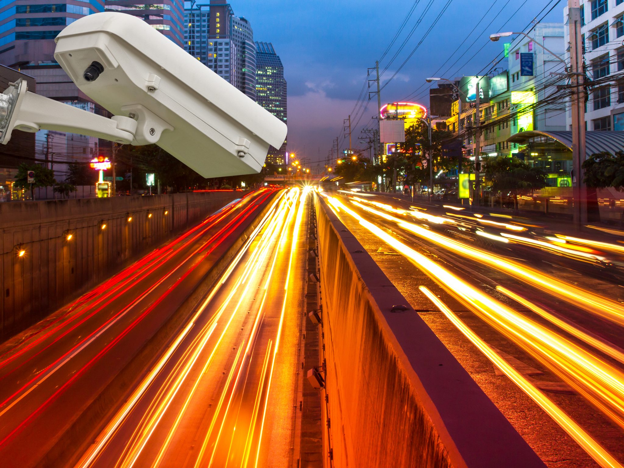 Surveillance camera against blurry city at night