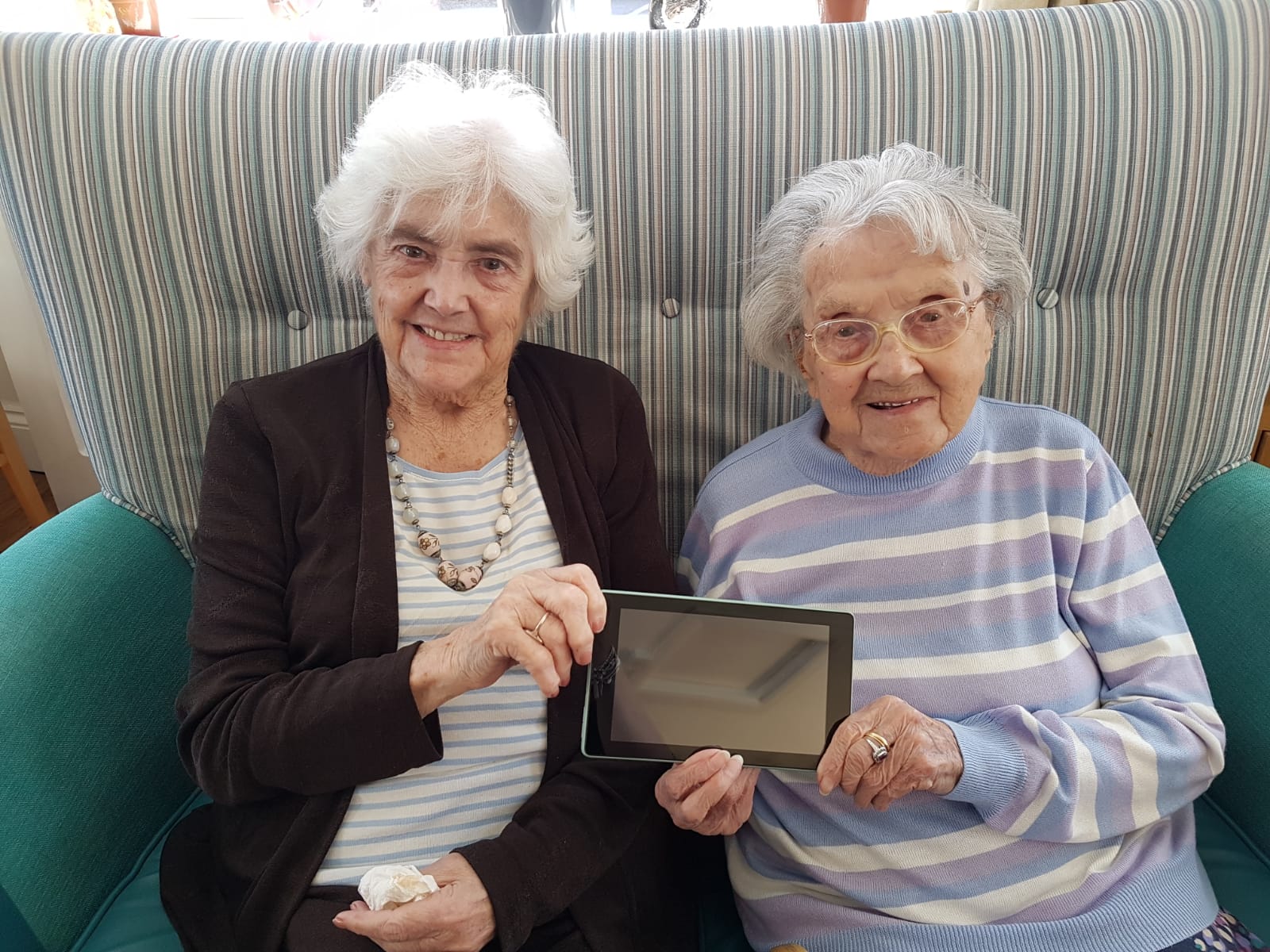 Two residents from Sandford Care Home with an iPad