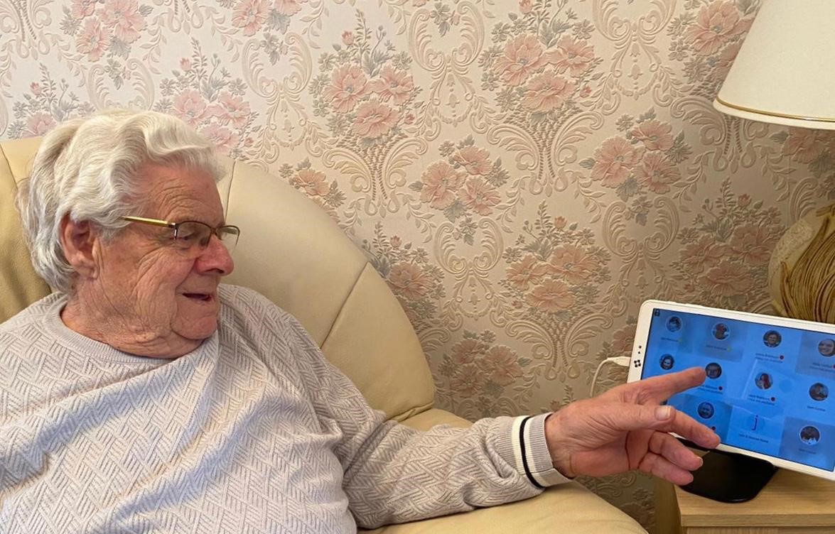 Elderly man operating Alcove Video Carephone