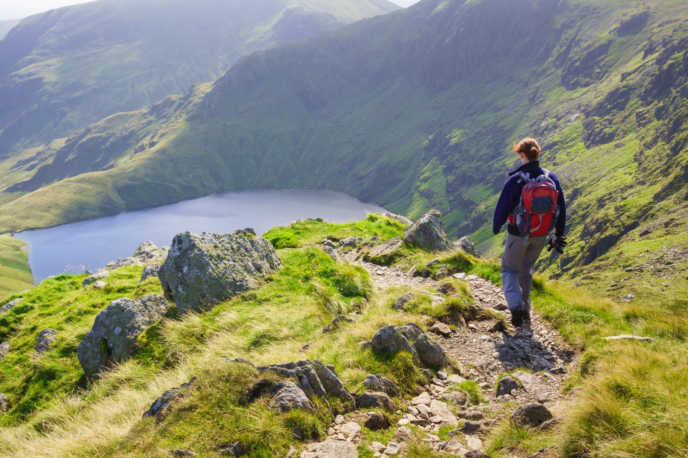 Female hiker walking in mountain scenery