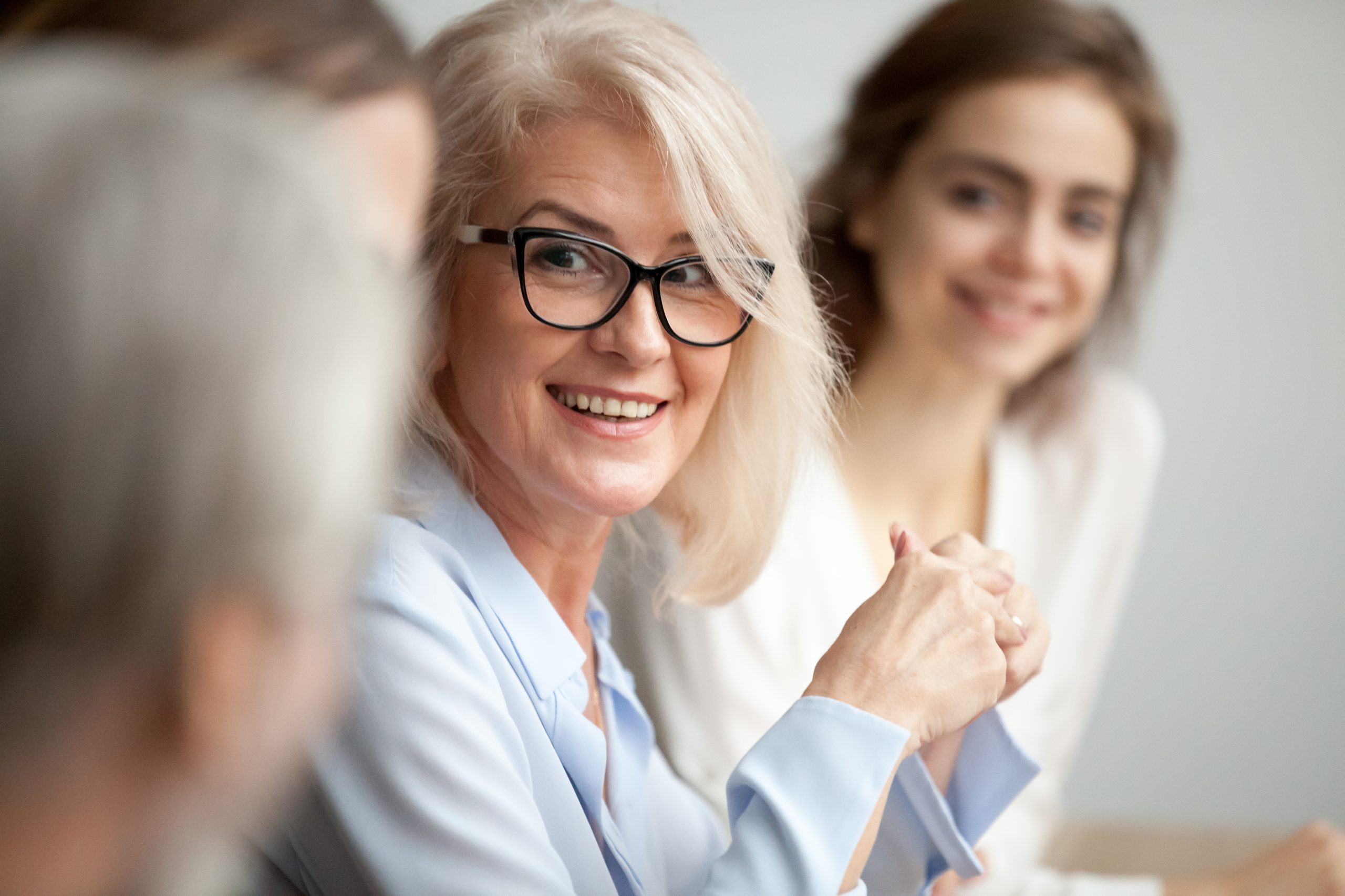 Image of older woman at a work meeting
