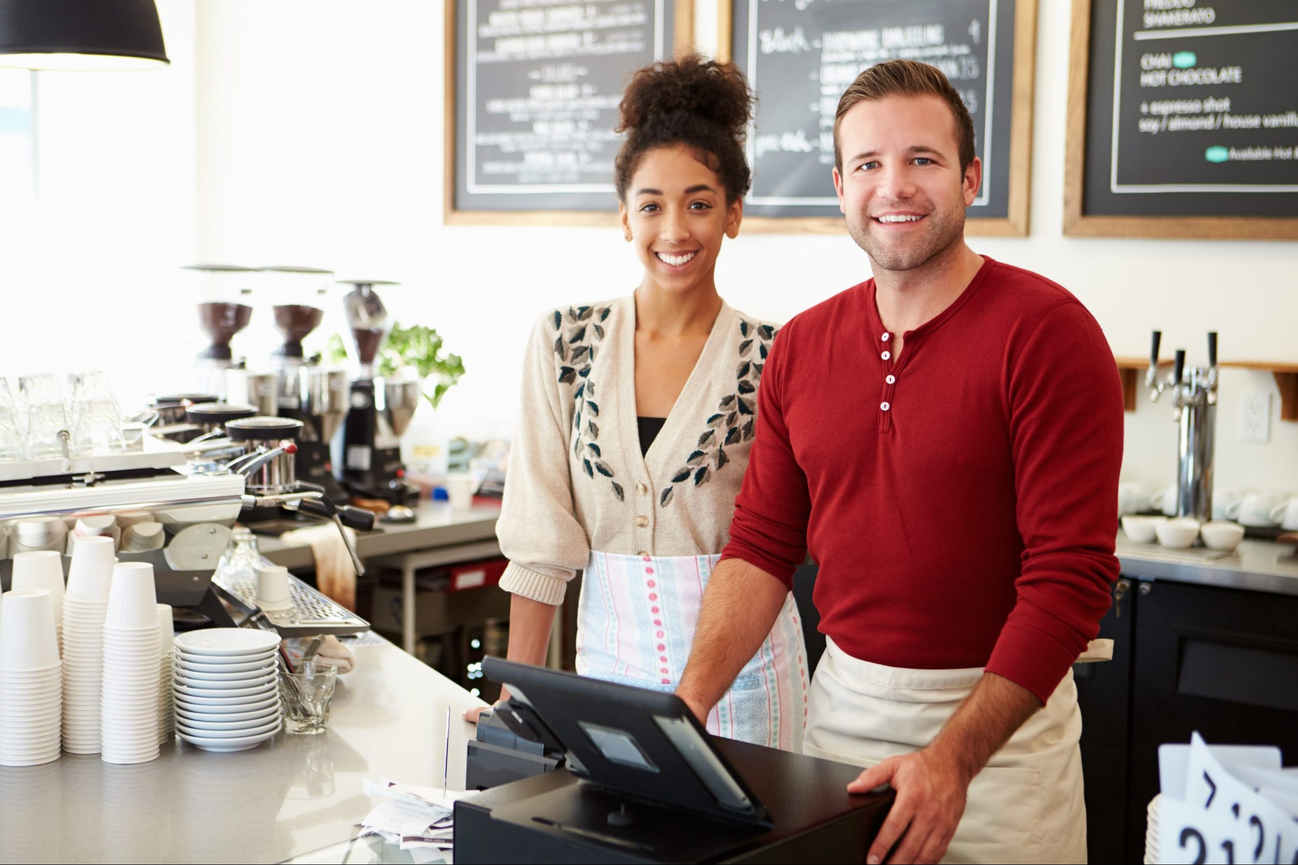 Male and female small business coffee shop owners
