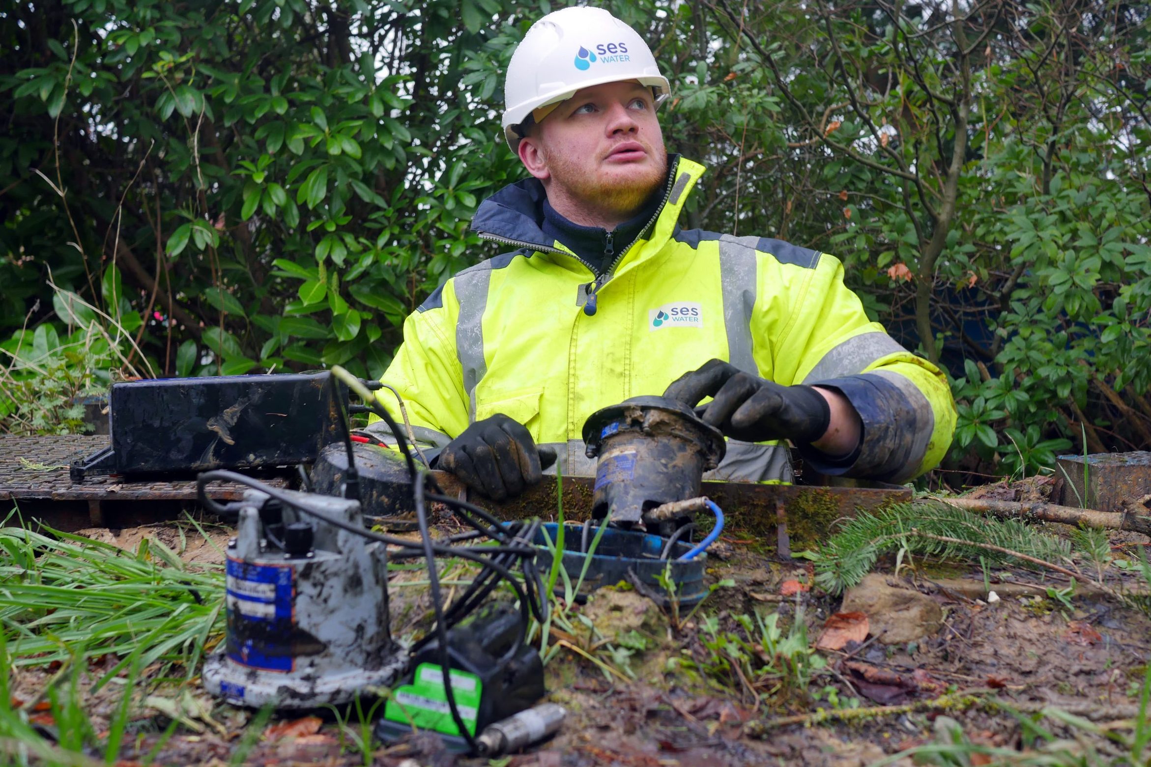 photo of an SES Water engineer attending to an IoT sensor