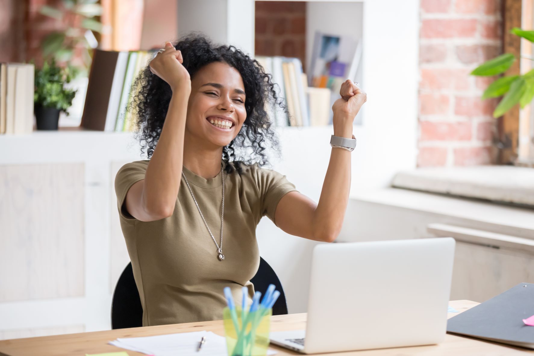 Young Woman Celebrating At Desk