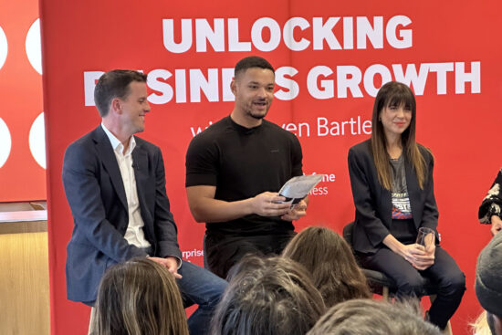 image of Steven Bartlett being given a bag of coffee at a Vodafone Pulse Connect event