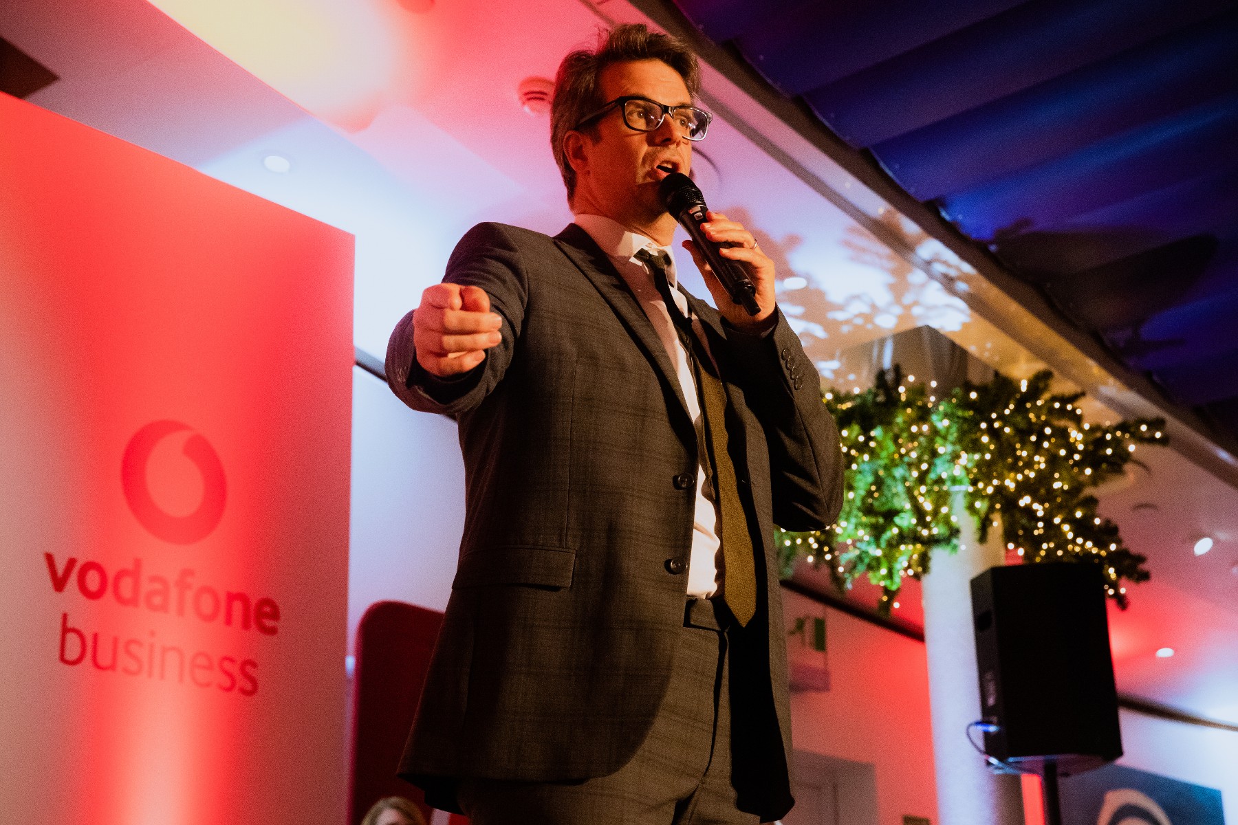 photo of comedian Marcus Brigstocke hosting a Vodafone Business awards ceremony for indirect sales partners