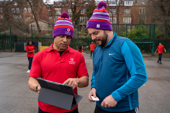 Ex-rugby winger Jason Robinson (left) showing Bankside Primary PE teacher Will Lancaster the PE Pro app, while being connected with a Vodafone everyone.connected SIM and MiFi.