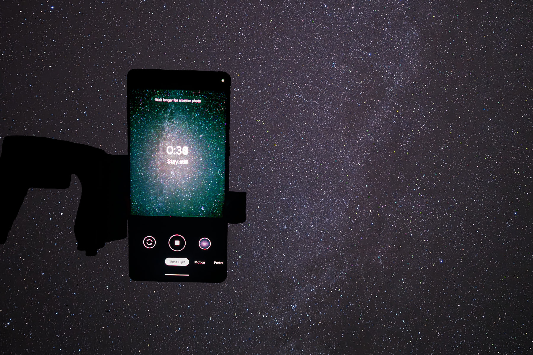 photo of a Google Pixel 7 Pro on a tripod pointing at a star-filled sky