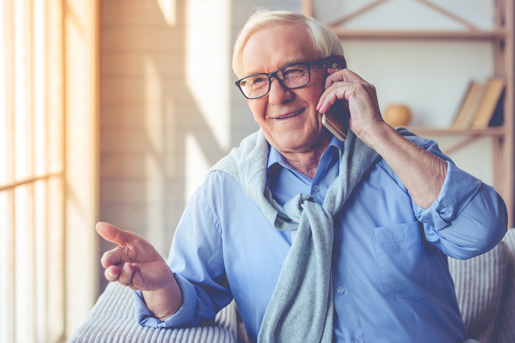 stock photo of a smiling middle aged man talking on a mobile phone
