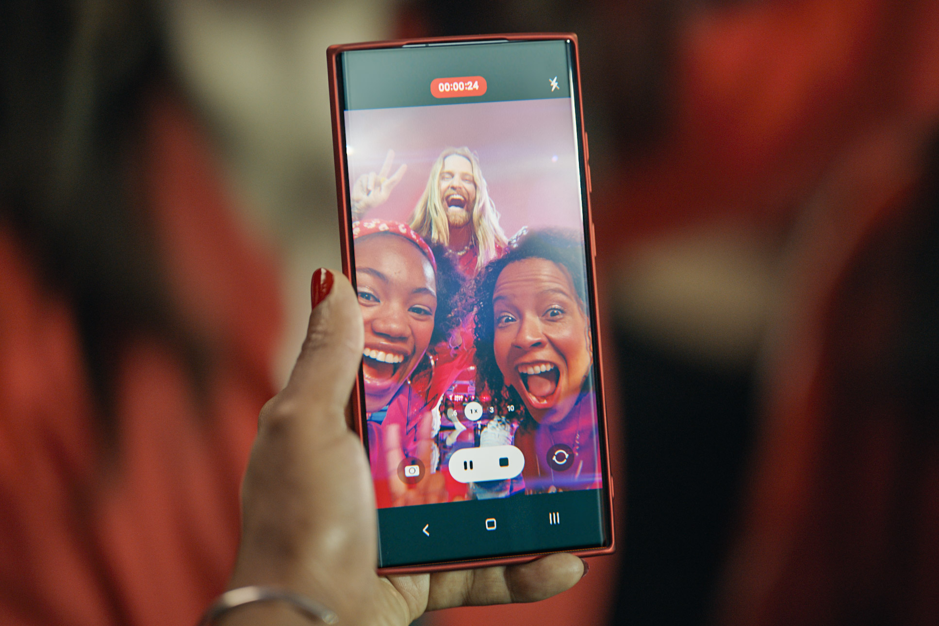 photo showing a selfie of Sam Ryder on a smartphone, promoting Vodafone's range of refurbished smartphones