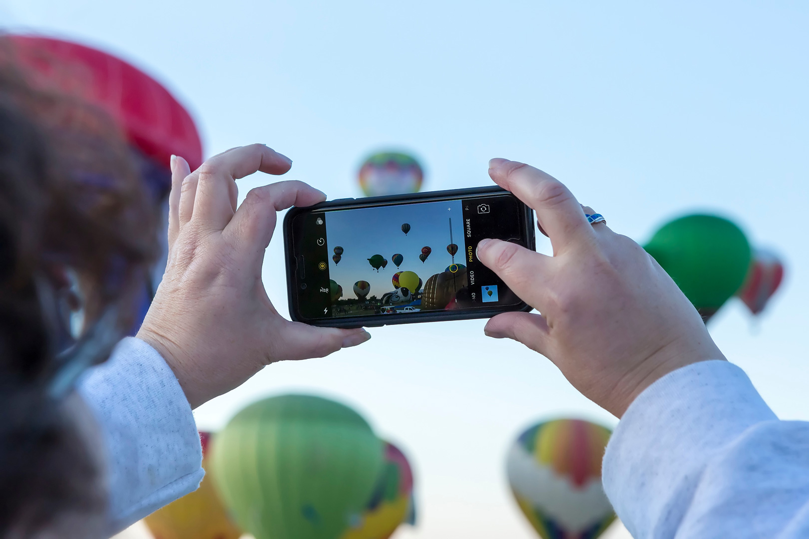 Spectator recording a balloon race using her phone