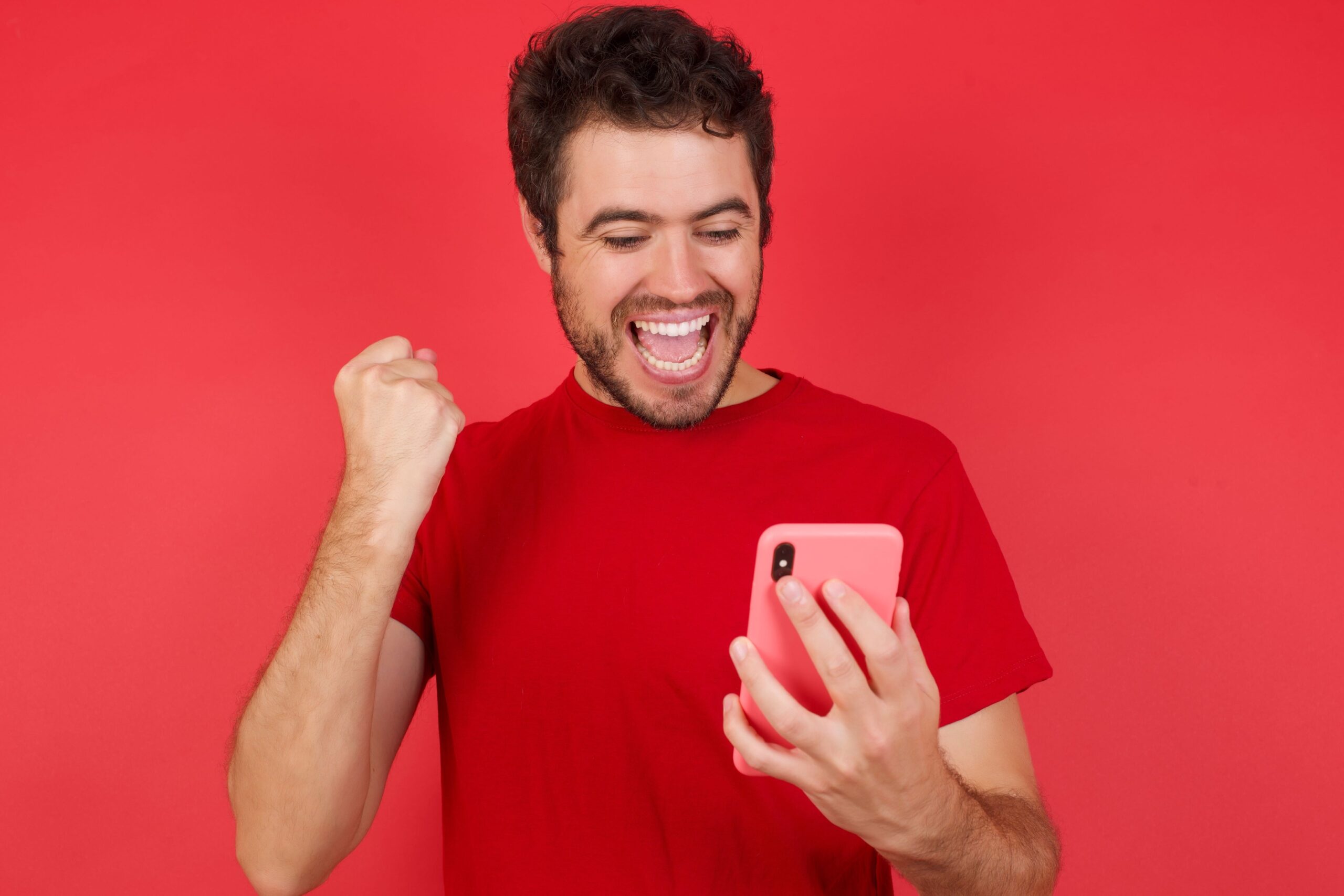 Young Man Celebrating With Phone
