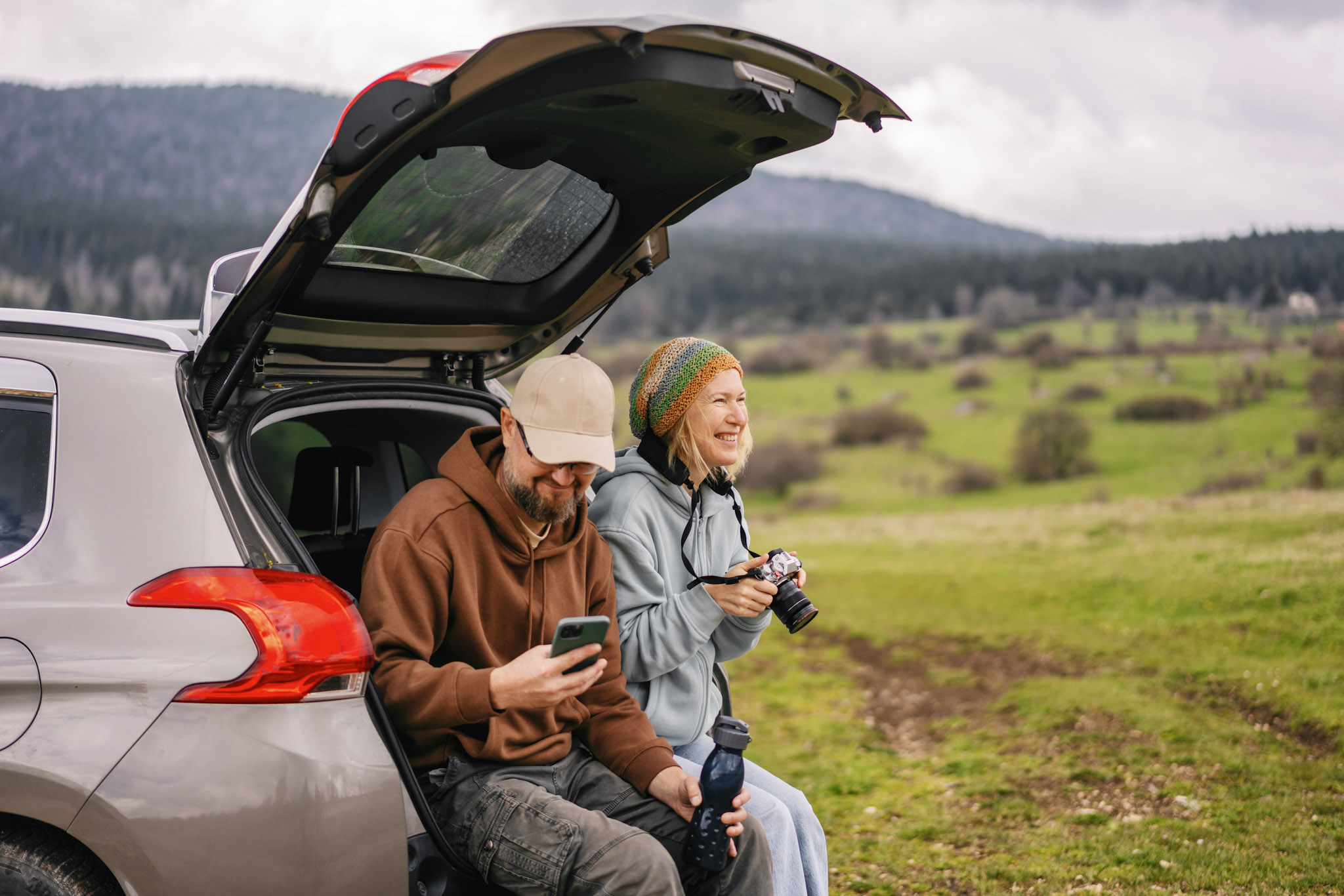 stock image of a middle-aged tourist couple on a roadtrip in the countryside
