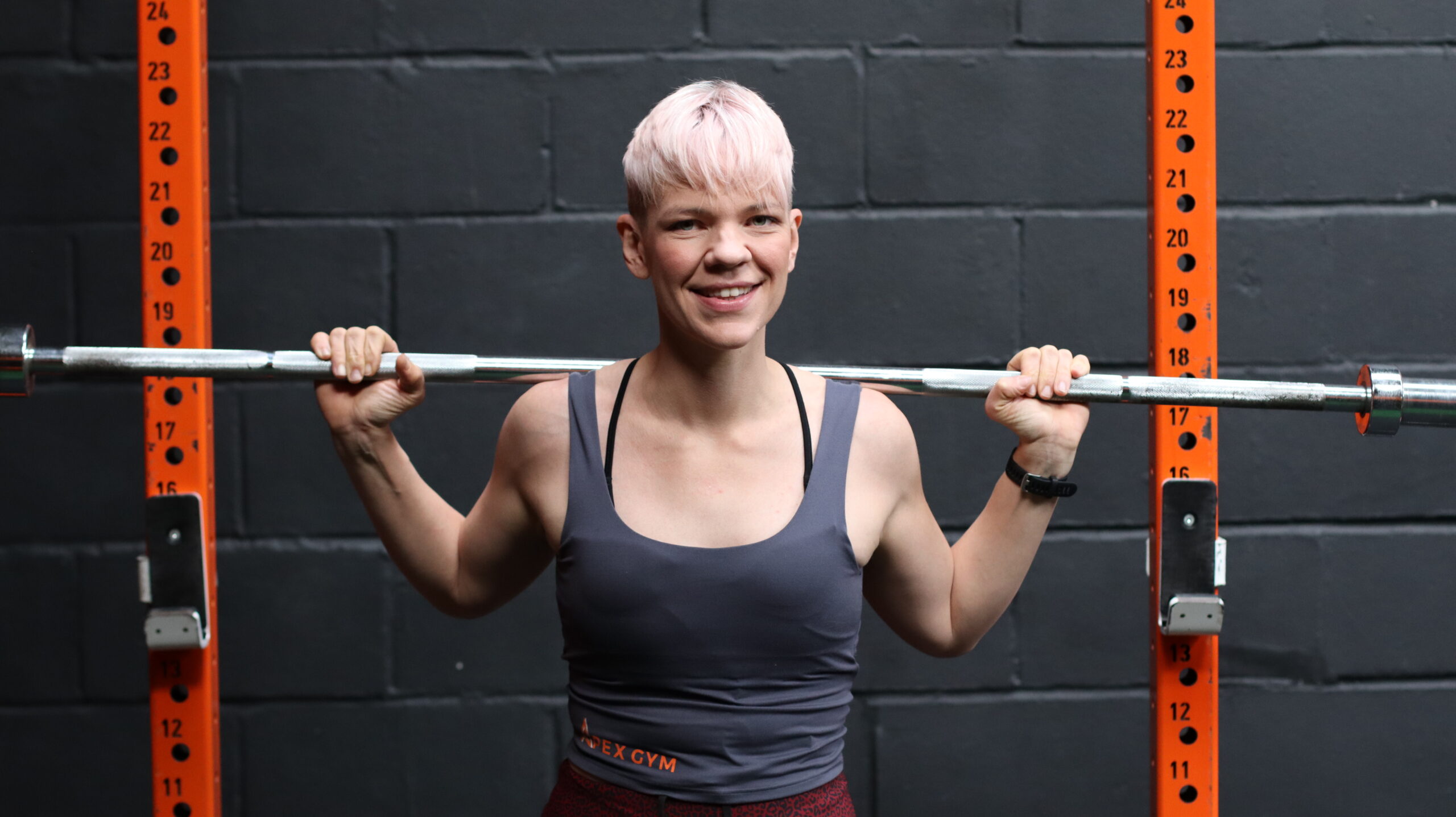 Amelia Lawes, Founder of Apex Gym, holding barbell