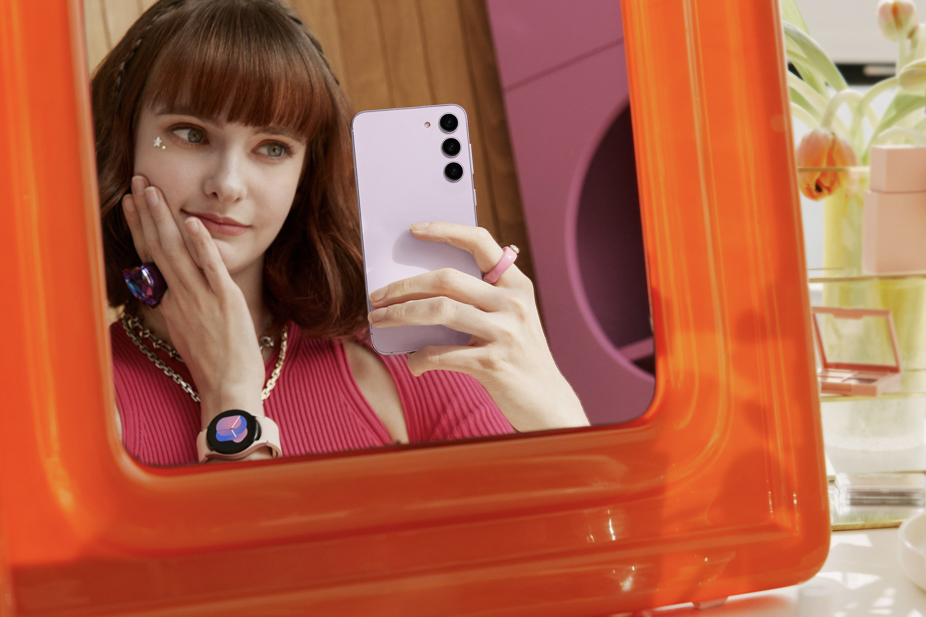 image of a young woman photographing herself in the mirror using a Samsung Galaxy S23 Plus Android smartphone