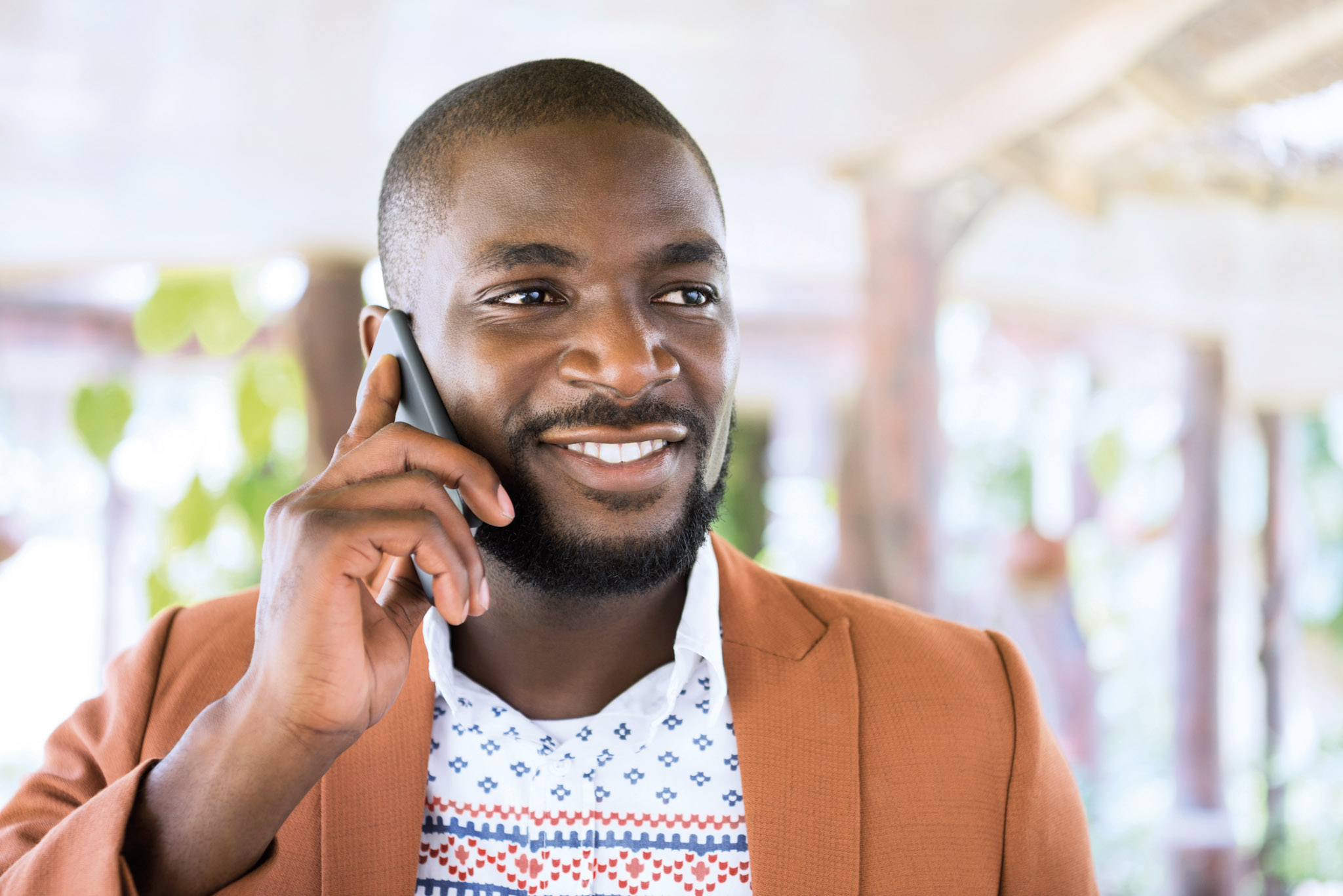 stock image of a man talking on a phone while standing outside
