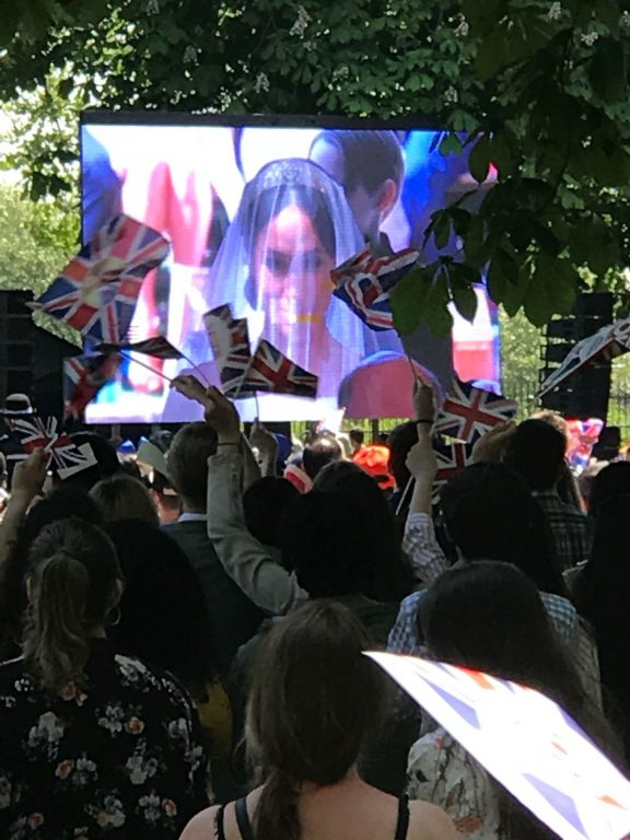 Photo of a crowd in Windsor watching the Royal Wedding and waving flags