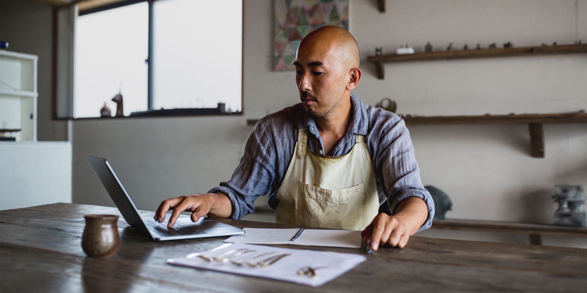 A small business owner using a laptop photo of a small business owner using a laptop