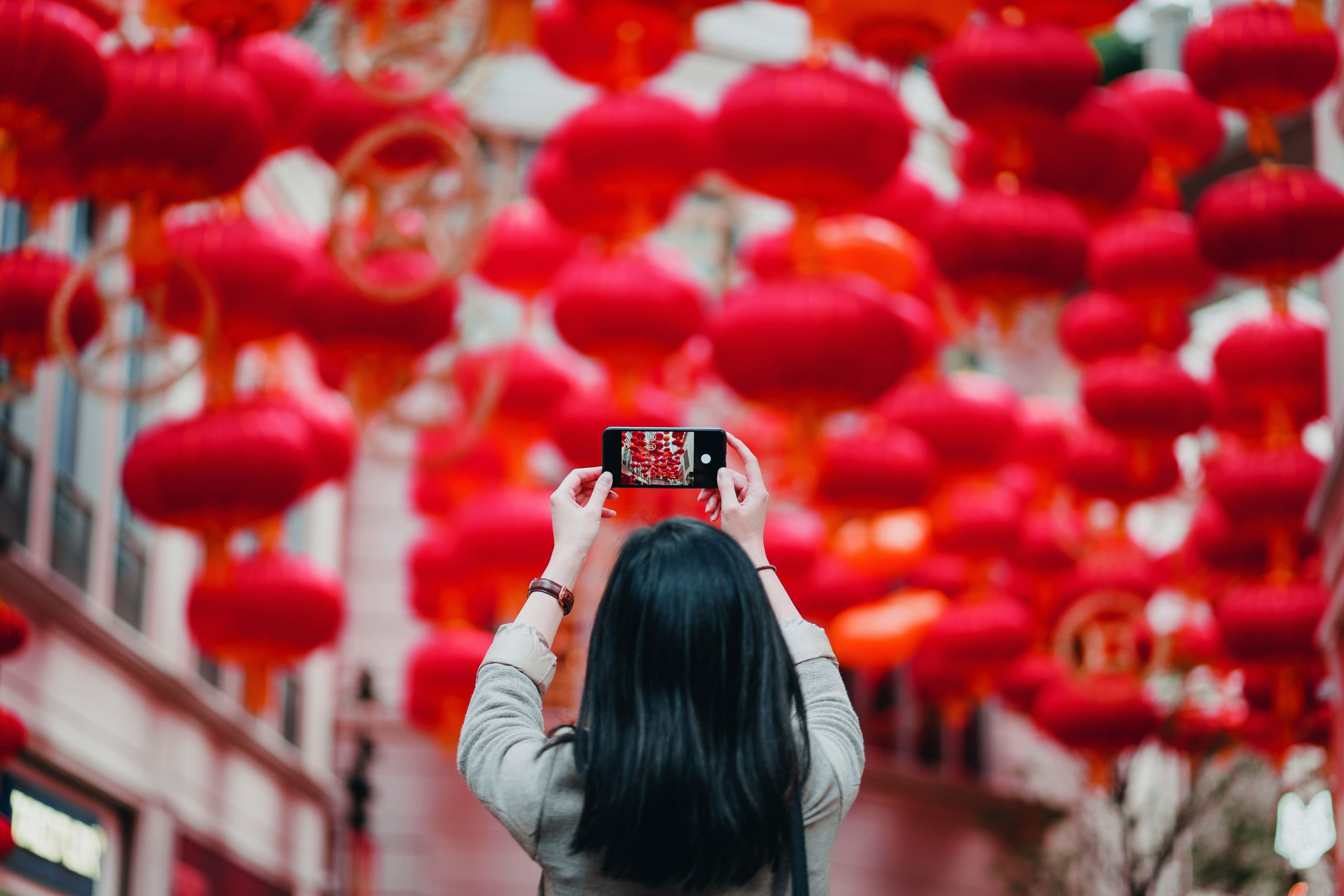 Image of young women taking a picture on phone.