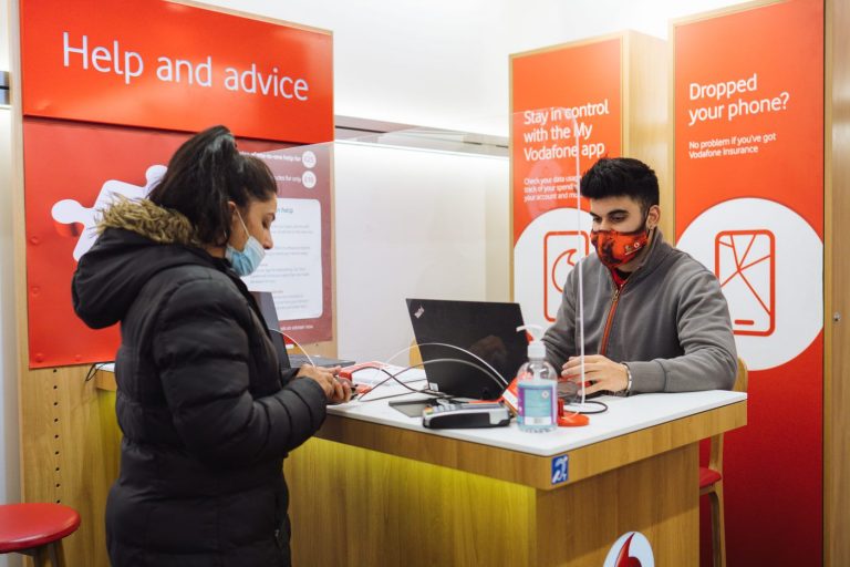 Vodafone retail store collague helping a customer