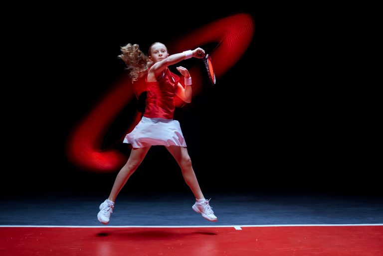 Young female tennis player caught in action shot PR Still