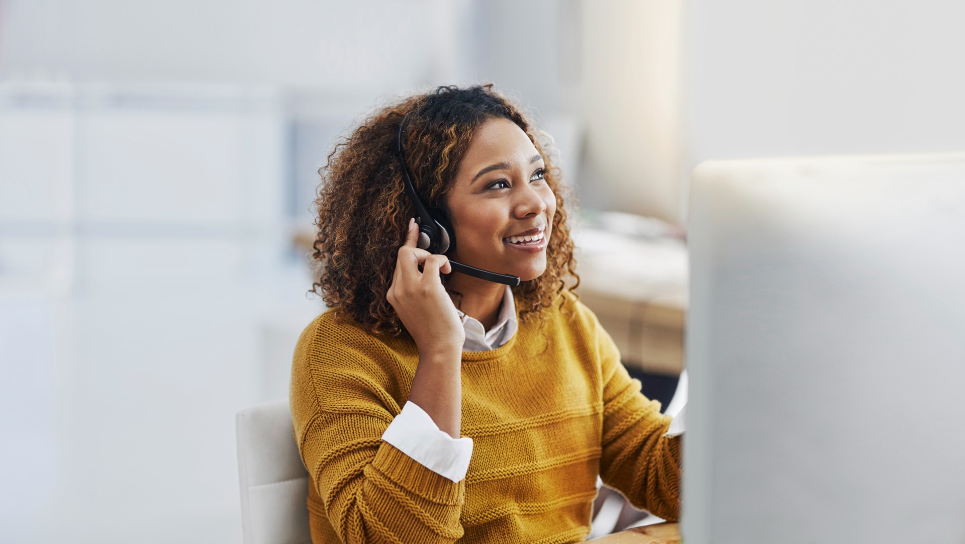 Woman in customer support speaking through headset.