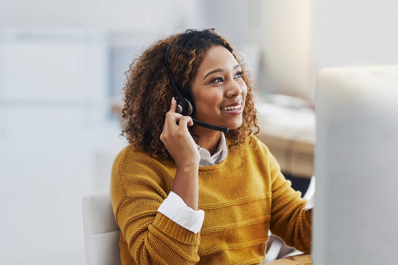 Woman in customer support speaking through headset.