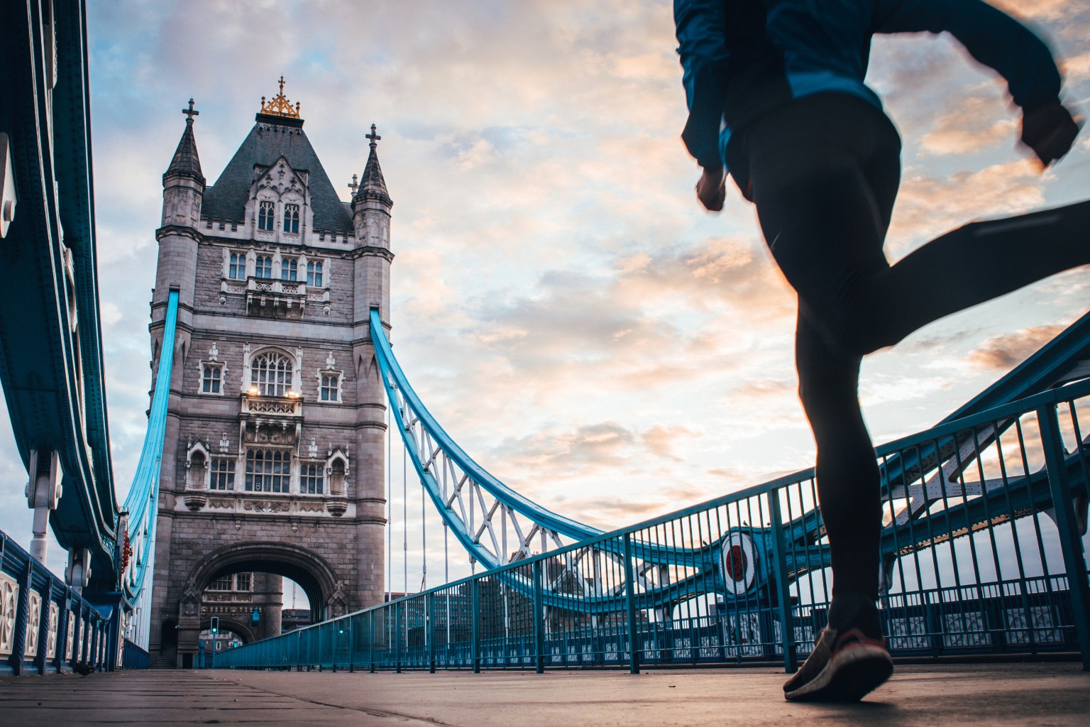 Person running across Tower Bridge in London.