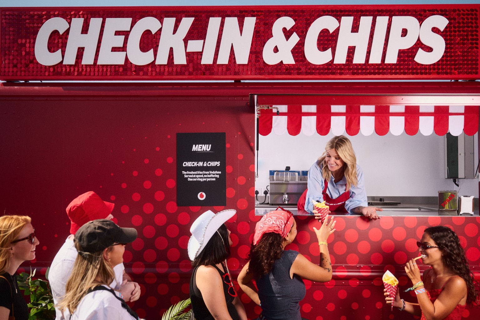 Zoe Ball- Vodafone Check-in & Chips 02(2) Zoe Ball serving free fries to festivalgoers out of food truck window.