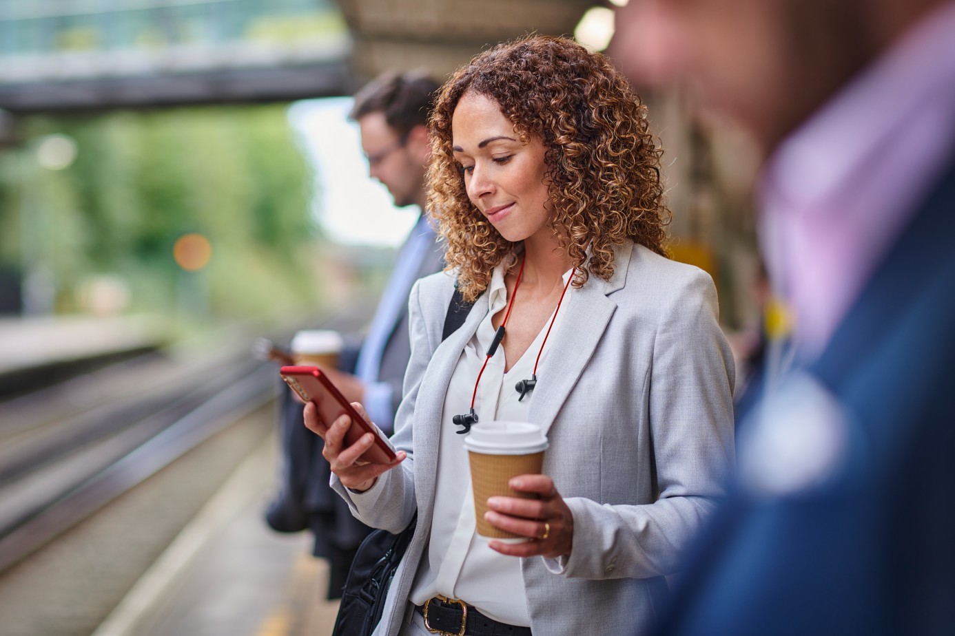 Woman on phone at train station.